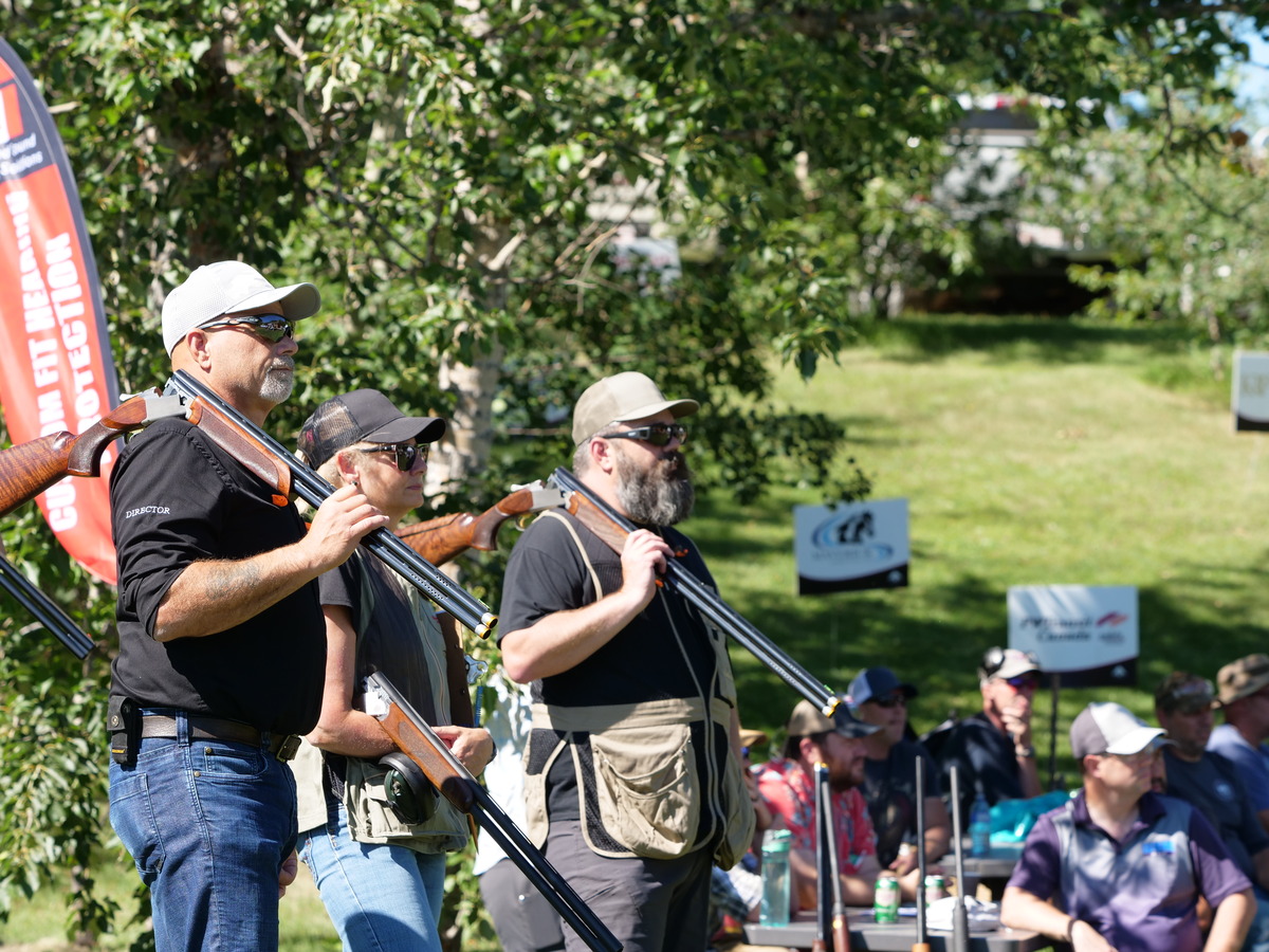 3 hunters stand at Waterfowl Warmup getting debriefed on the days activities